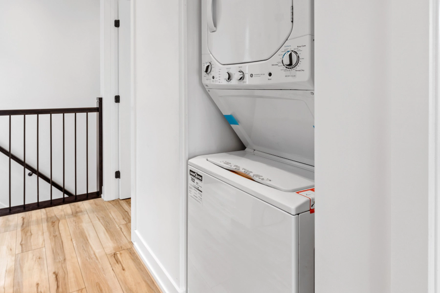 white washer and dryer machine on a white walled room